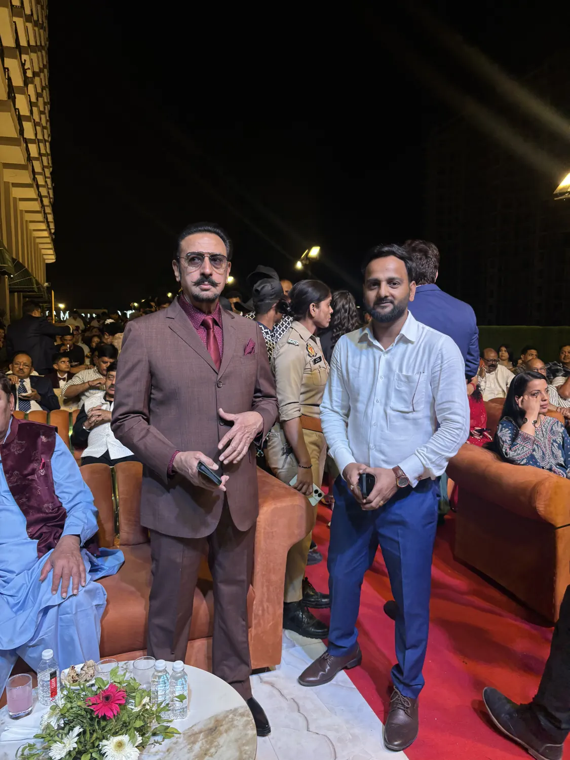 Rahul Awasthi standing among guests at an evening event